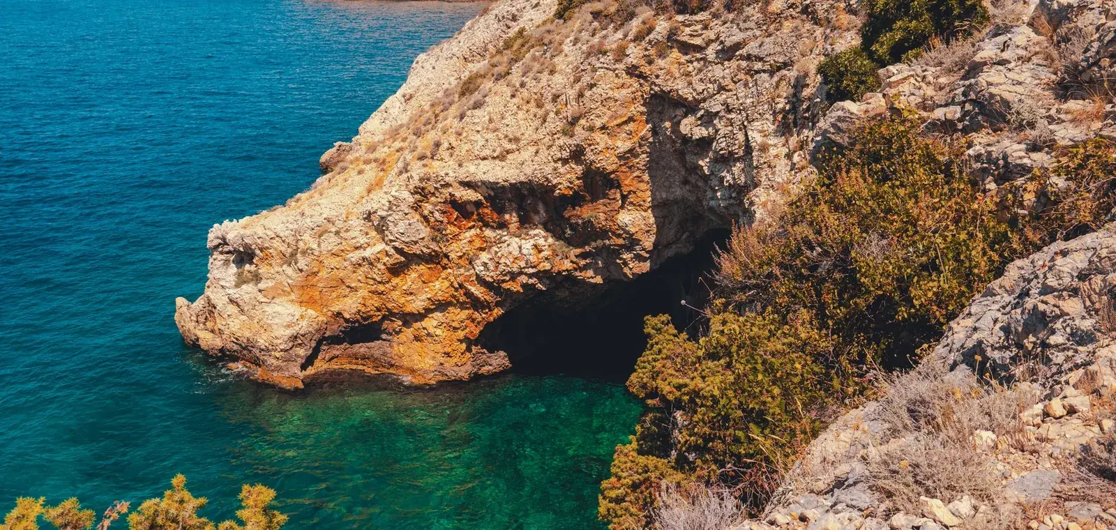Rocky coastline with a natural arch and clear turquoise water on the island of Krk, Croatia