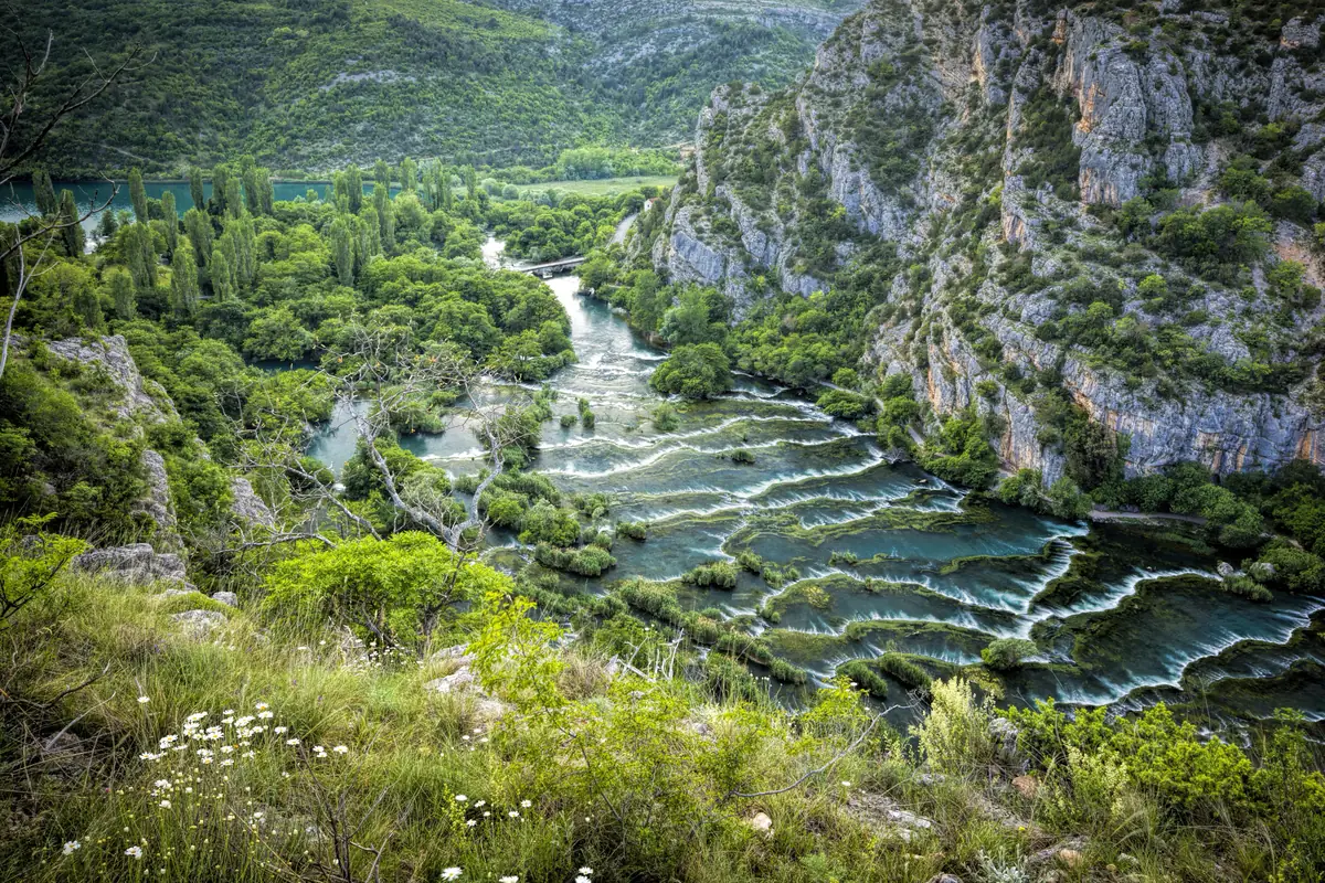 River terraces and small cascades in a green limestone canyon in the Krka valley, Croatia