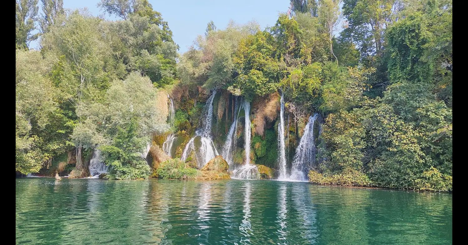 A wide curtain of waterfalls dropping into a turquoise pool in Krka National Park, Croatia